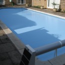 Solar powered automatic swimming pool cover.